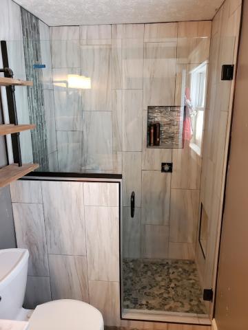 A wonderful glass enclosed shower shaped with right angles 