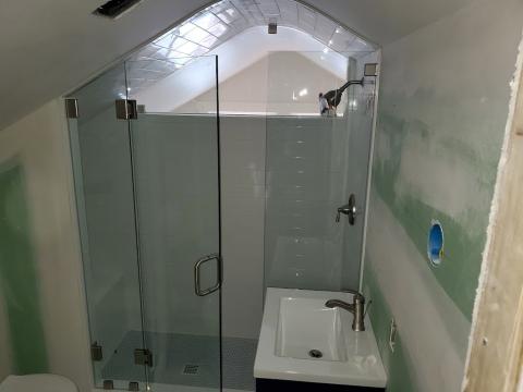 A complex shaped glass shower door